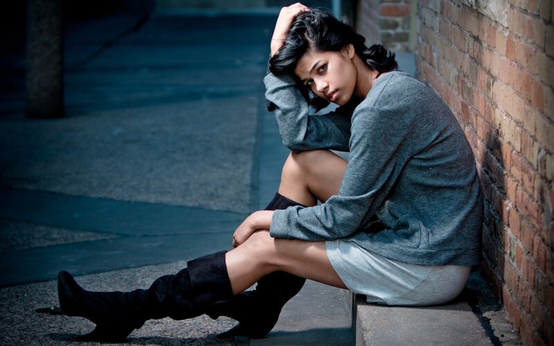 Woman Sitting on Sidewalk — Gray, Dramatic