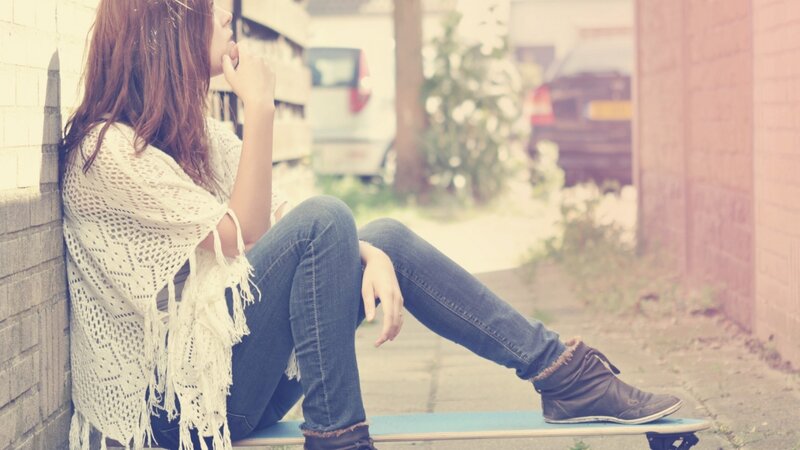 woman sitting on skateboard