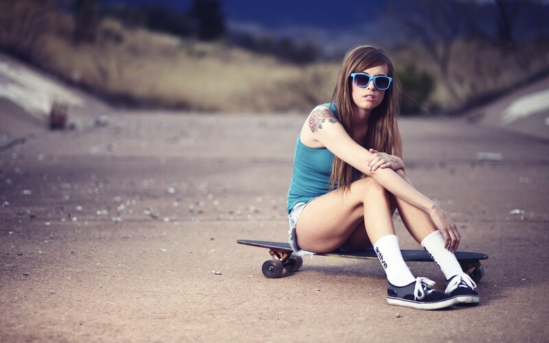 woman sitting on skateboard