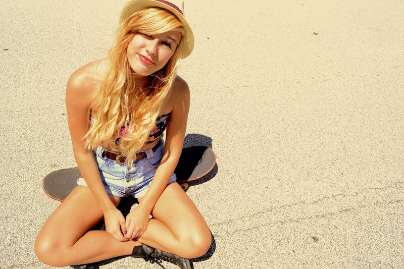 woman sitting on skateboard