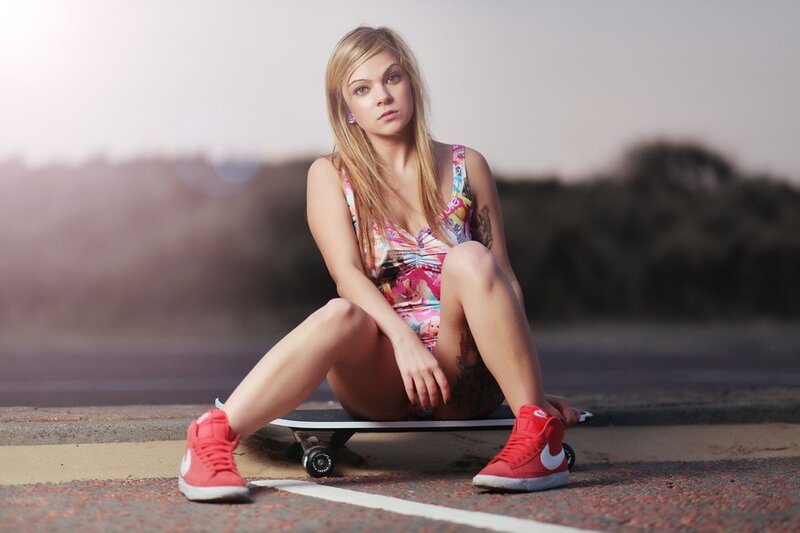 woman sitting on skateboard