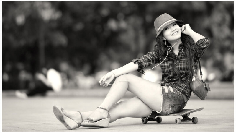 Woman Sitting on Skateboard — Black, Relaxed