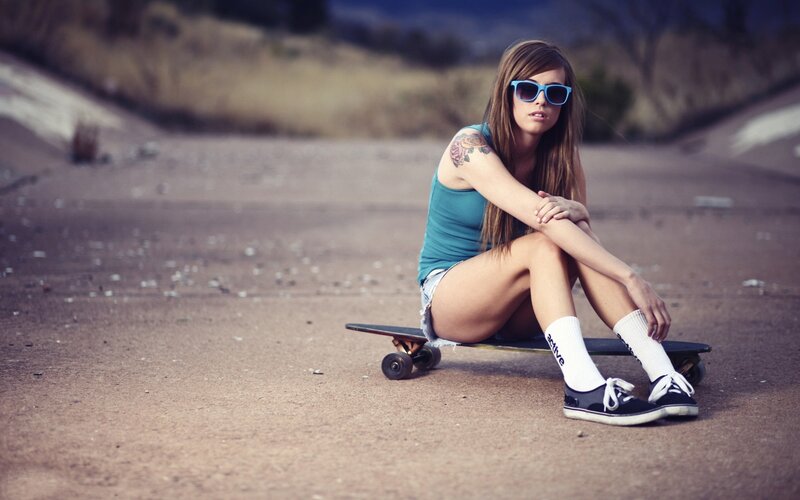 Woman Sitting on Skateboard — Brown