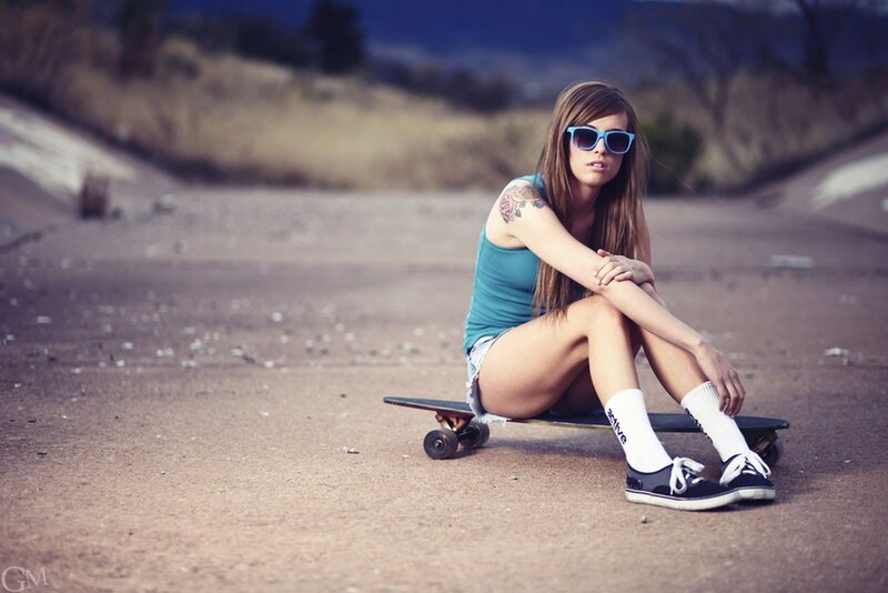 woman sitting on skateboard