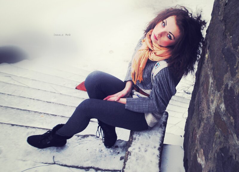 woman sitting on snowy steps