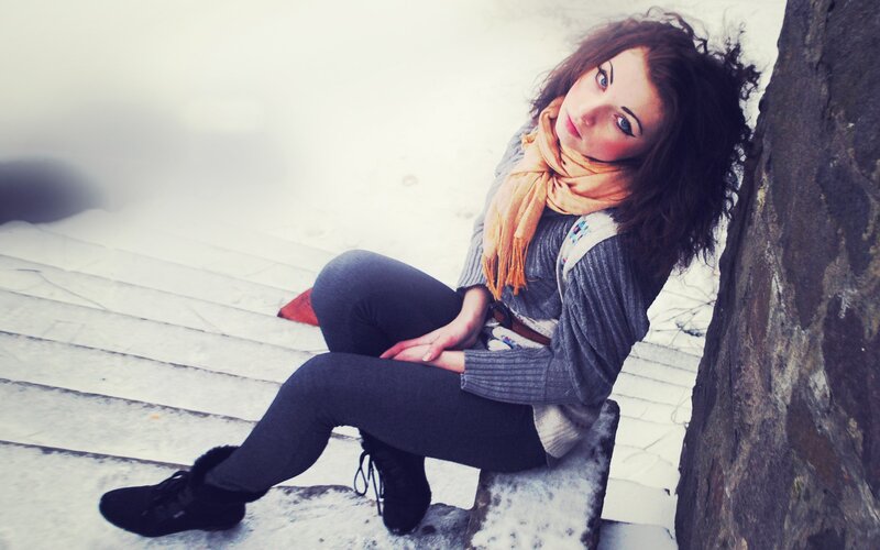 woman sitting on snowy steps