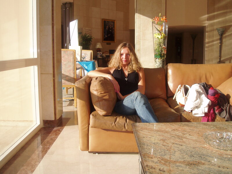 Woman Sitting on Sofa — Brown