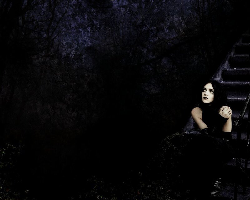 woman sitting on stairs at night