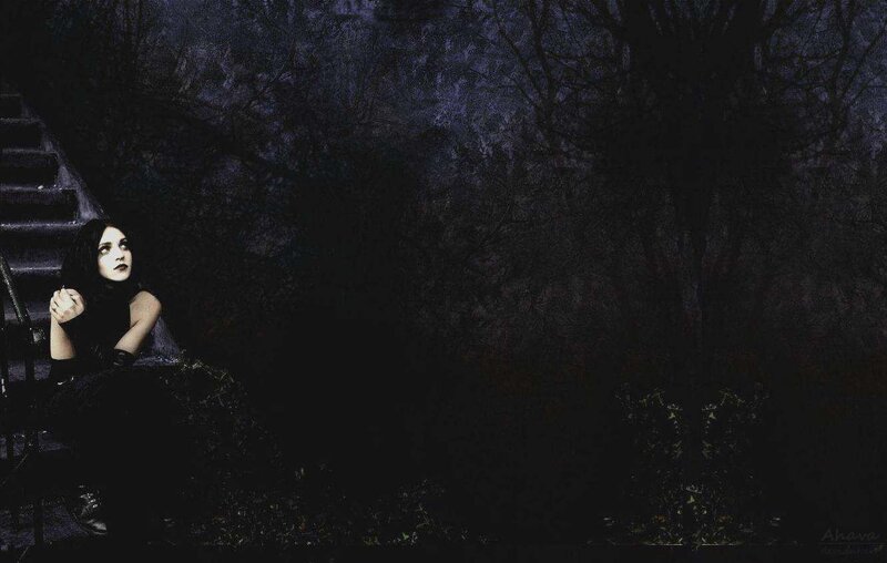 woman sitting on stairs at night