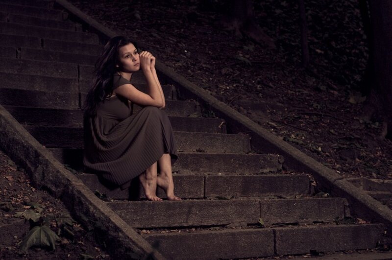 Woman Sitting on Stairs — Brown, Somber