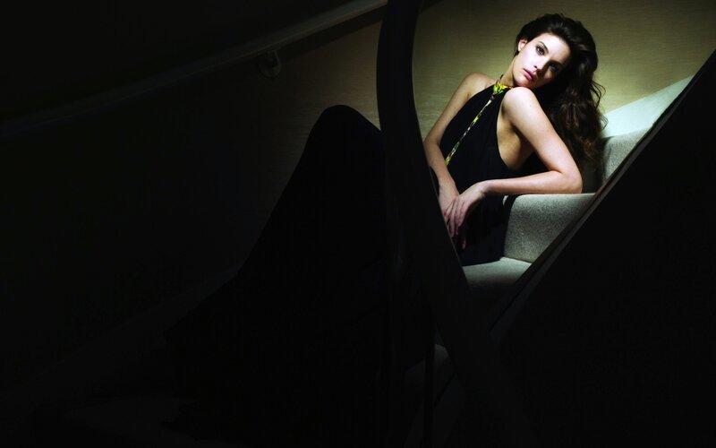 woman sitting on stairs in dim light
