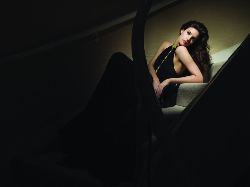 woman sitting on stairs in dim light