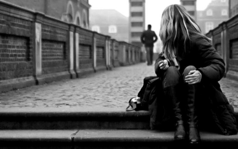 Woman Sitting on Steps — Black, Somber, Photograph, Person, Building