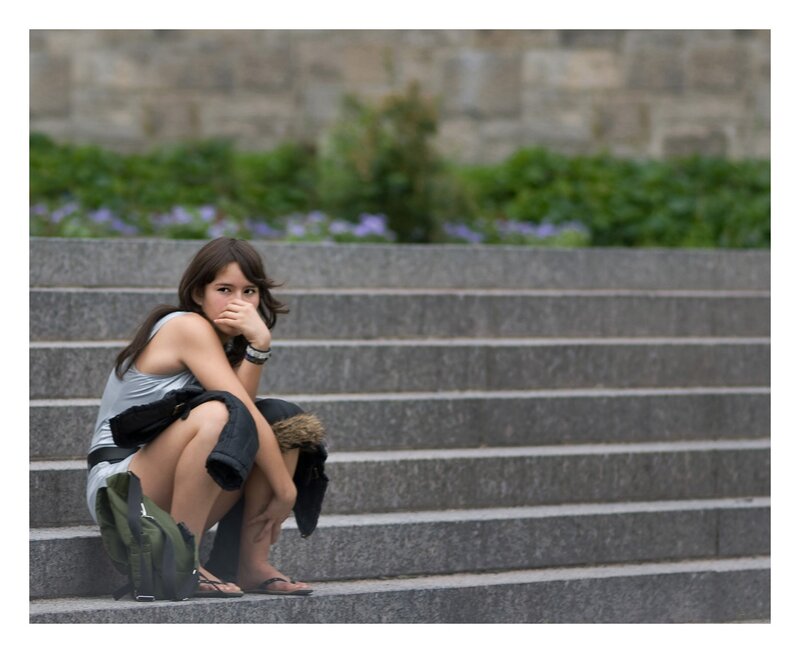 Woman Sitting on Steps — Gray, Contemplative, Afternoon, Photograph, Backpack