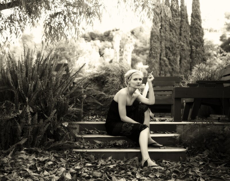 Woman sitting on steps in garden