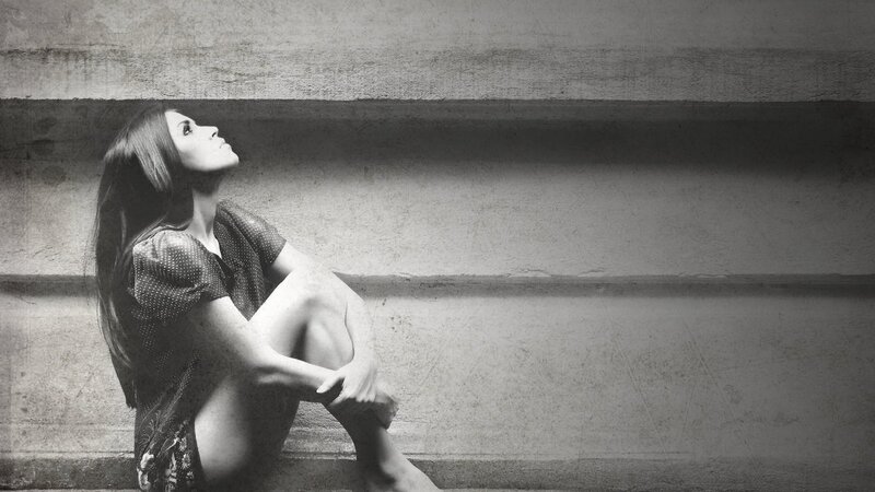woman sitting on steps looking up