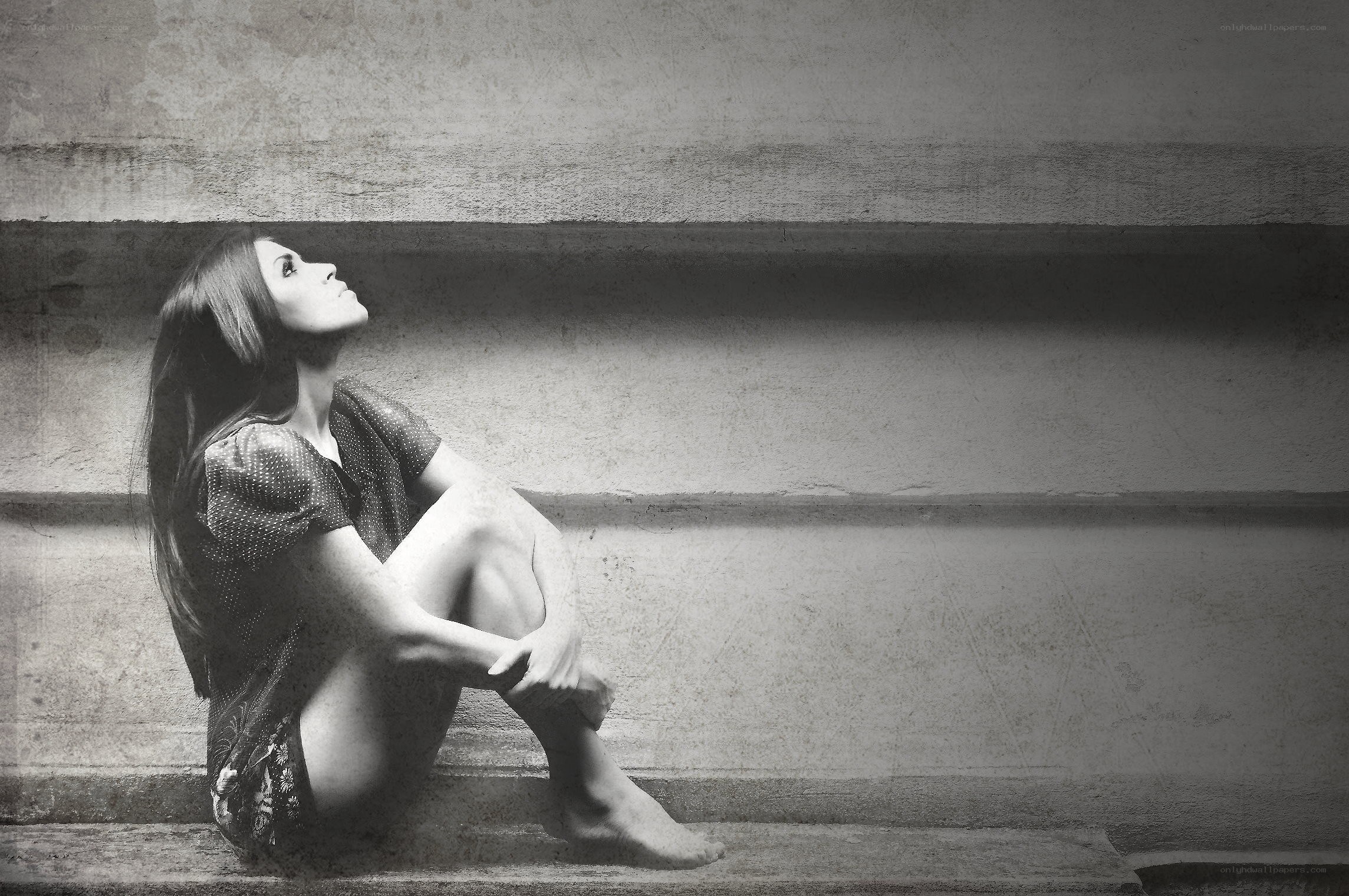 woman sitting on steps looking up
