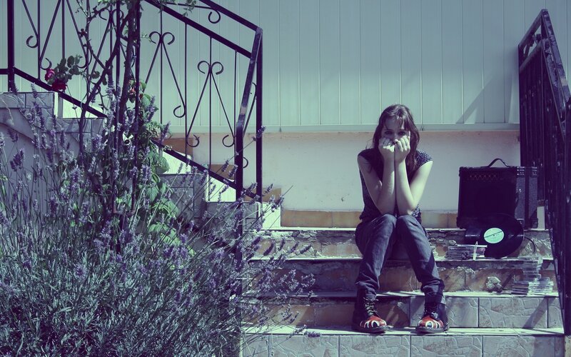 Woman Sitting on Steps — Purple