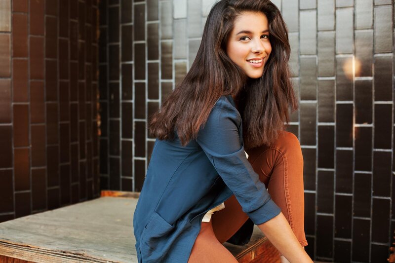 woman sitting on steps smiling