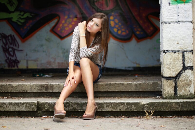 woman sitting on steps with graffiti