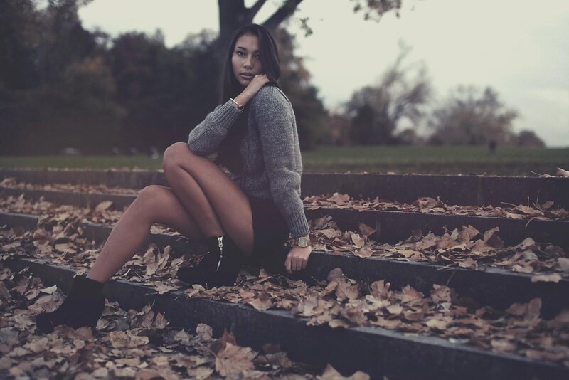 woman sitting on steps with leaves