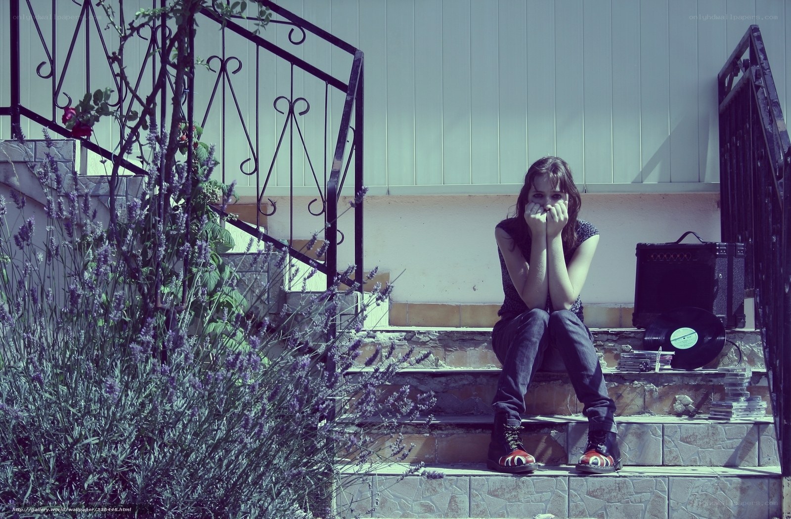 woman sitting on steps with record player