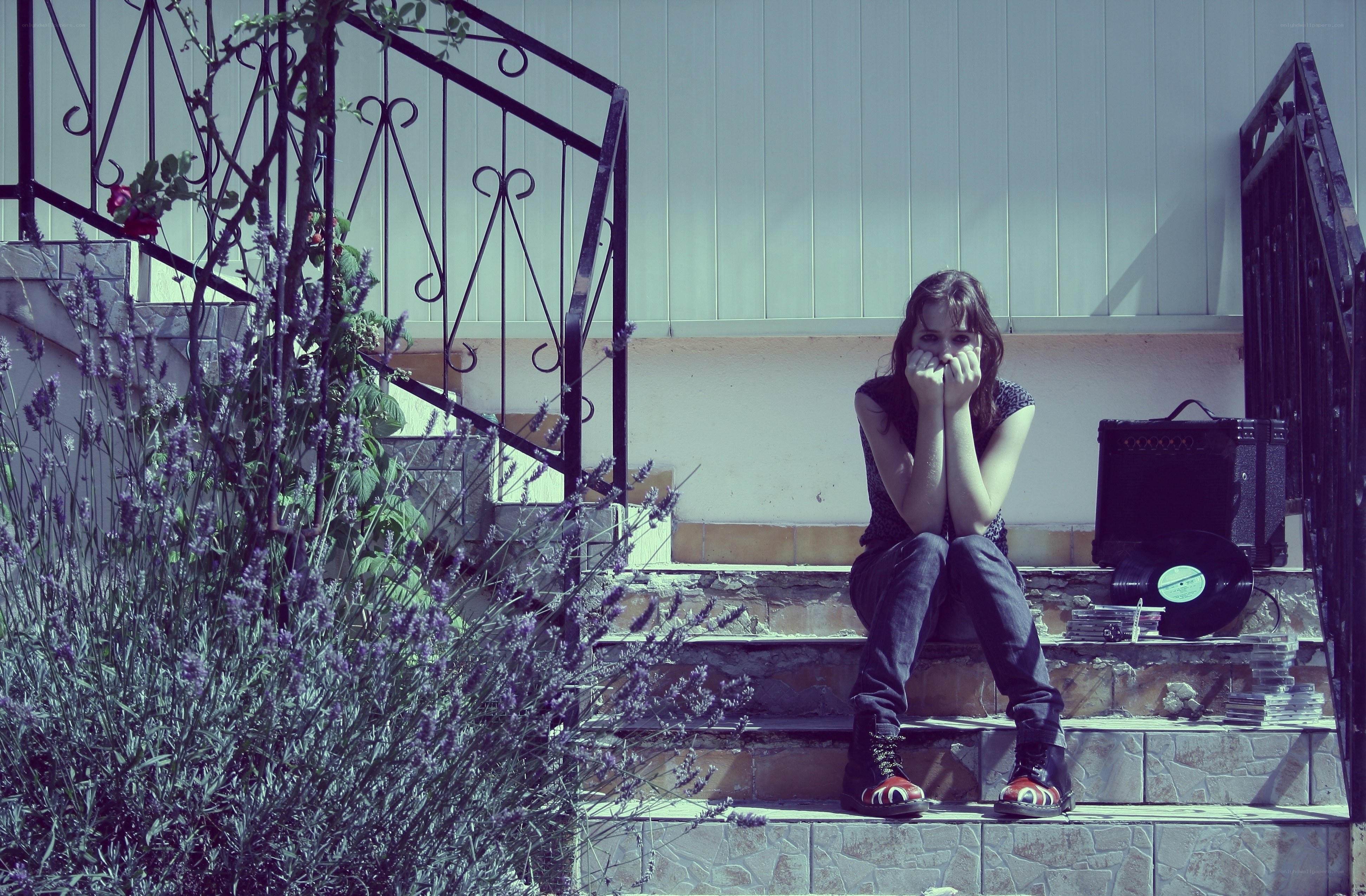 woman sitting on steps with record player