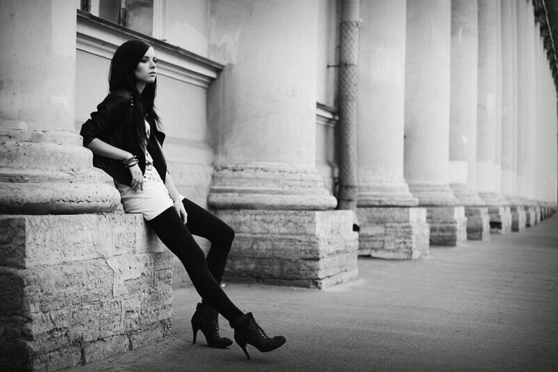 woman sitting on stone pillar