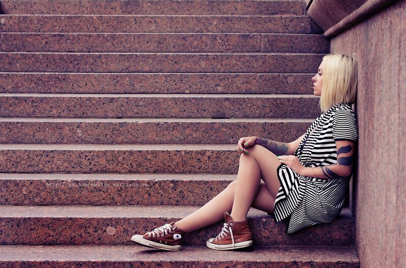 Woman sitting on stone steps