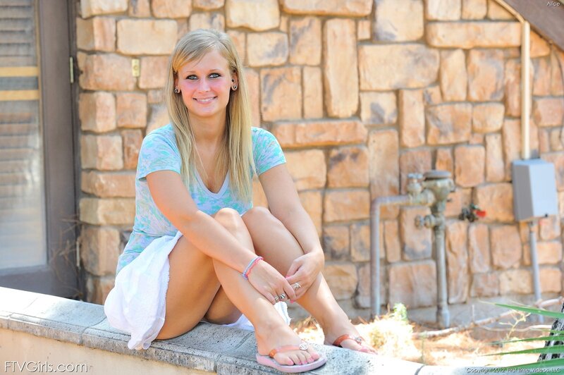 woman sitting on stone wall