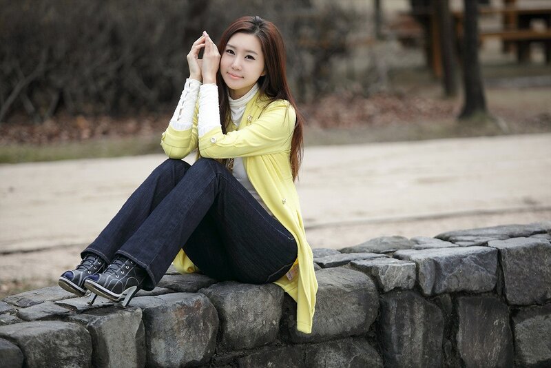 Woman Sitting on Stone Wall — Yellow