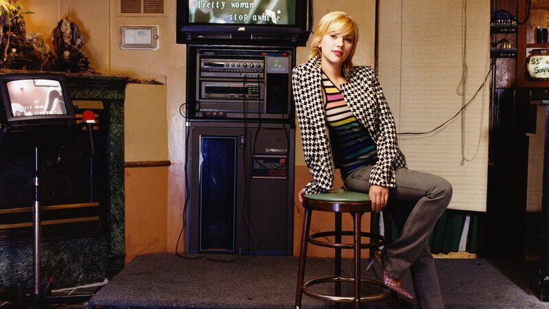 Woman Sitting on Stool — Black, Neutral, Photograph, Television, Audio Equipment