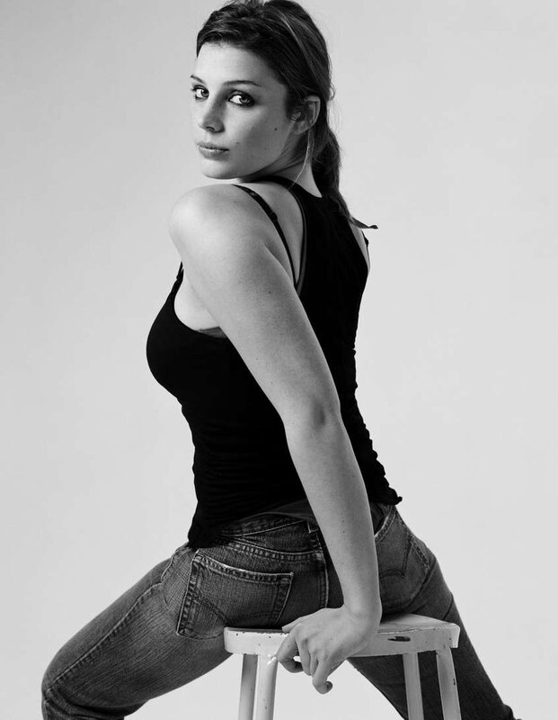 woman sitting on stool in black and white