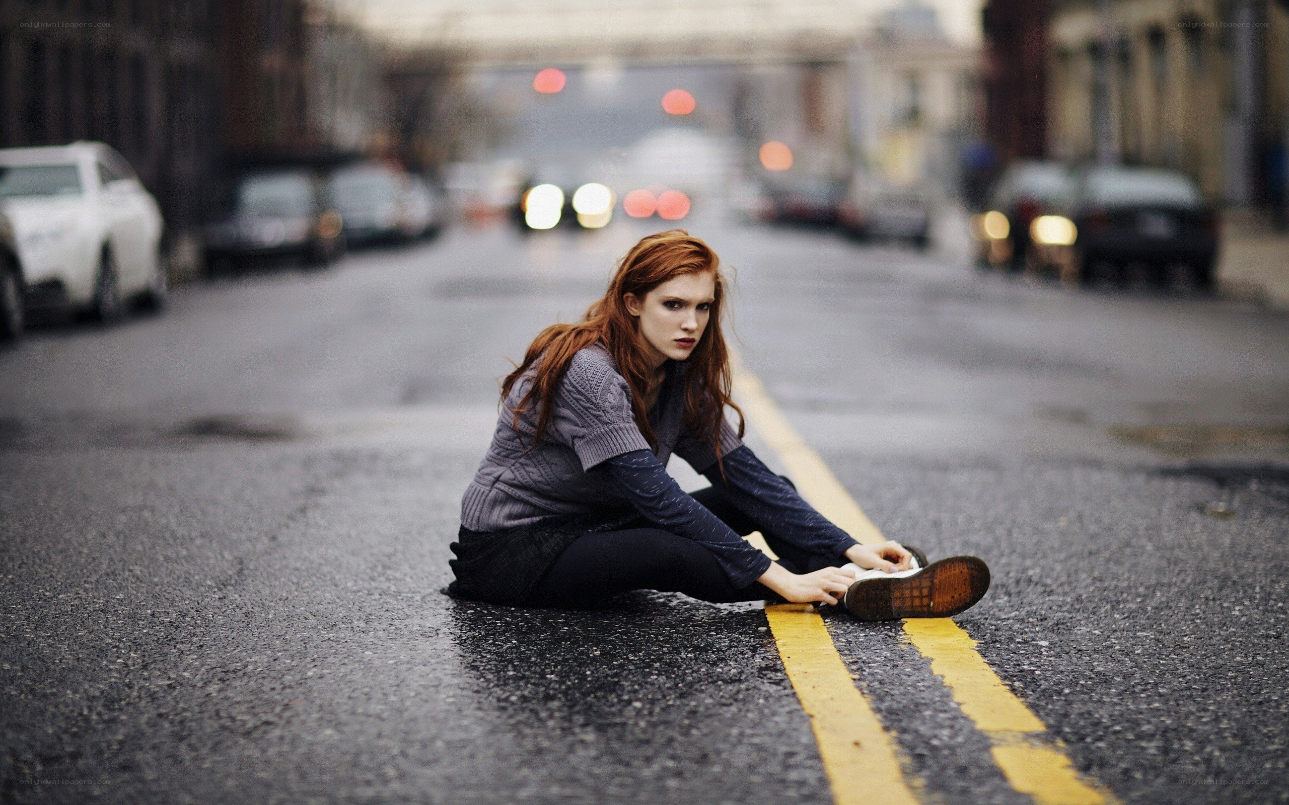 Woman sitting on street