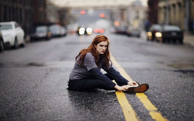 Woman sitting on street