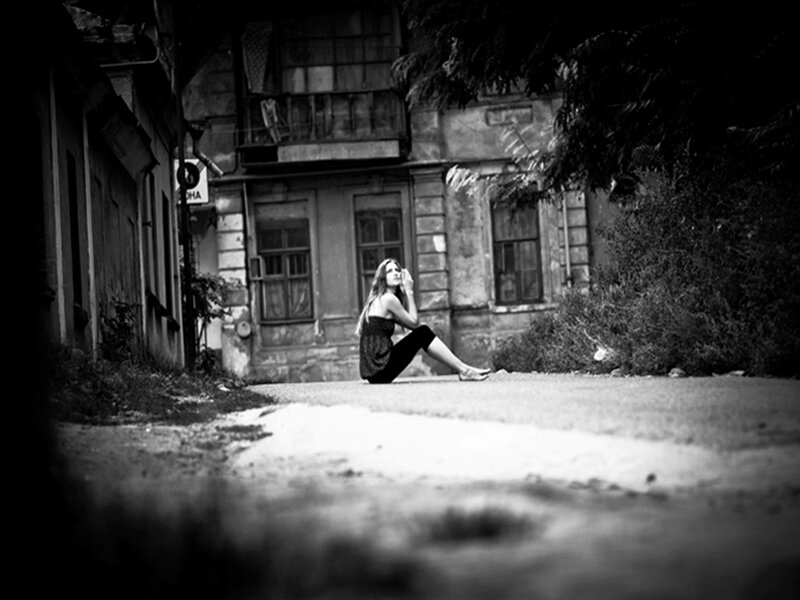 Woman Sitting on Street — Black