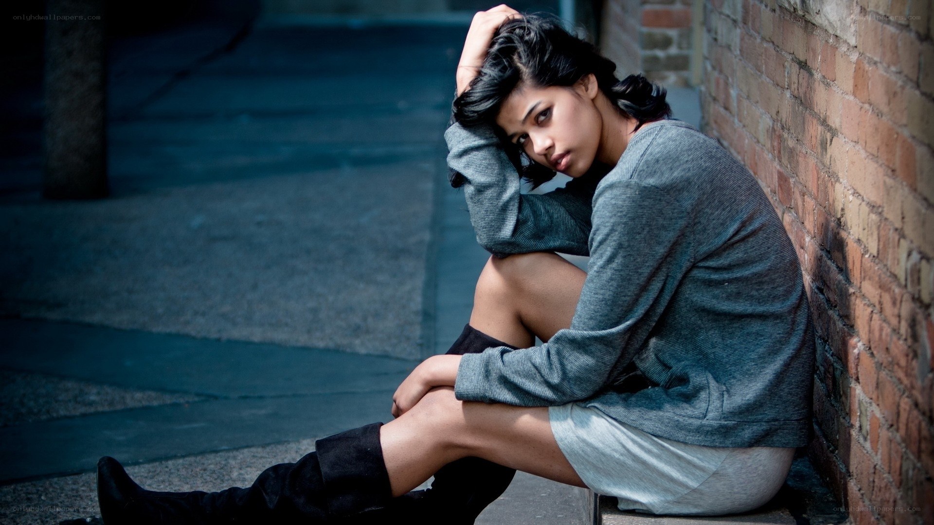 woman sitting on street
