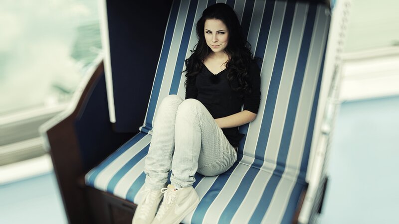 woman sitting on striped chair
