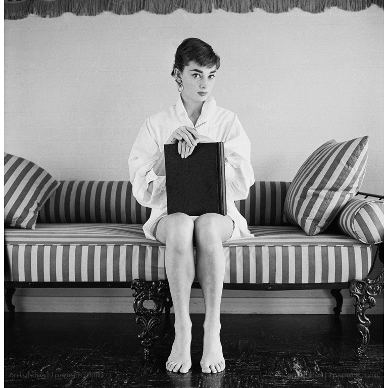 woman sitting on striped couch