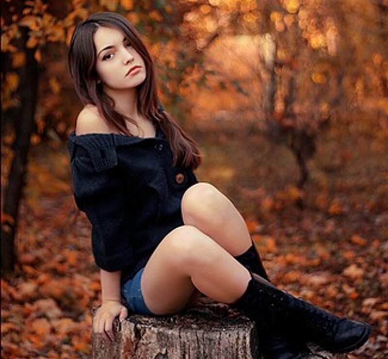 Woman Sitting on Stump — Orange