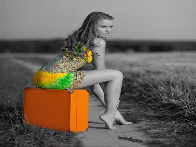 woman sitting on suitcase
