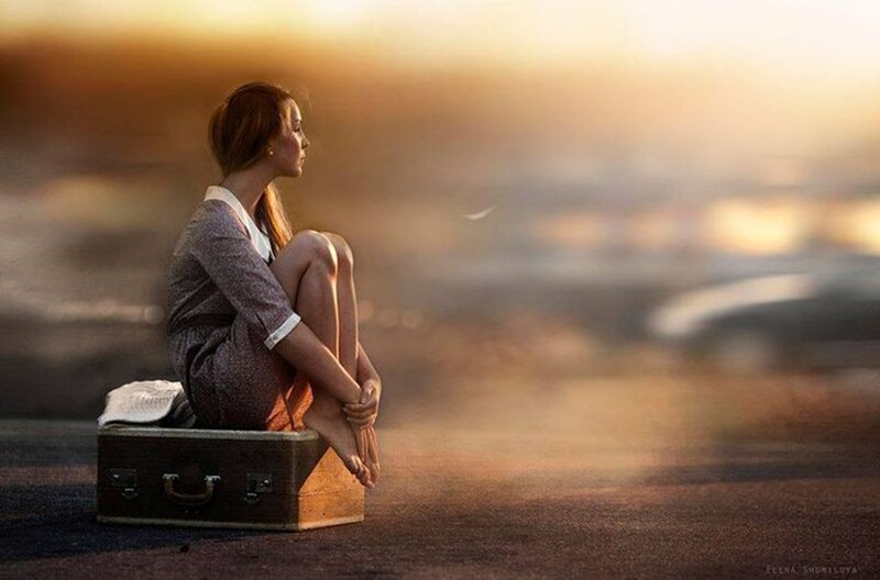 Woman Sitting on Suitcase — Gold