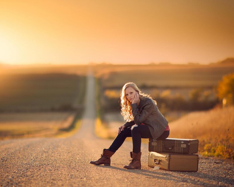 Woman Sitting on Suitcases — Golden