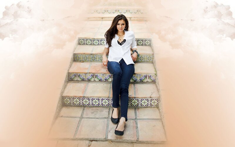 woman sitting on tiled stairs
