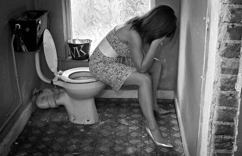 Woman Sitting on Toilet