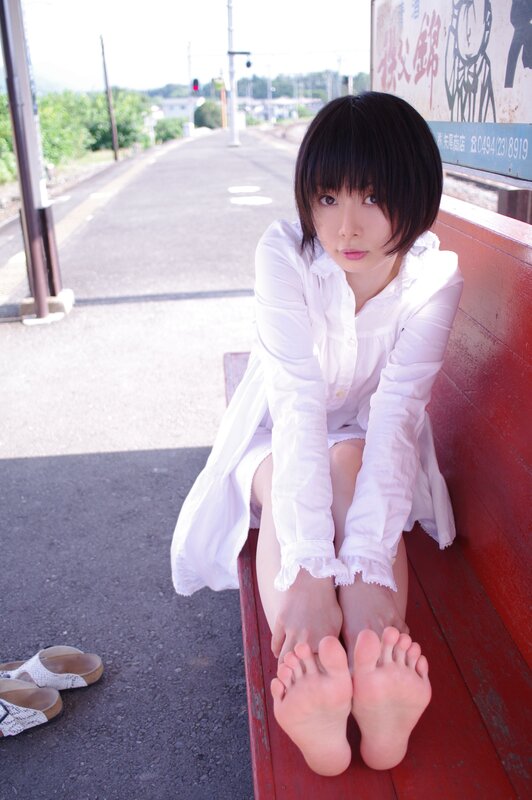 Woman sitting on train station bench