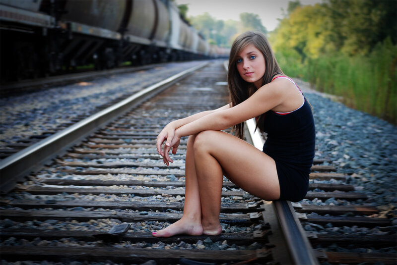 Woman Sitting on Train Tracks — Black, Contemplative, Afternoon