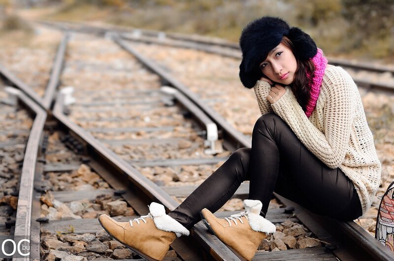 Woman Sitting on Train Tracks — Black, Contemplative, Winter