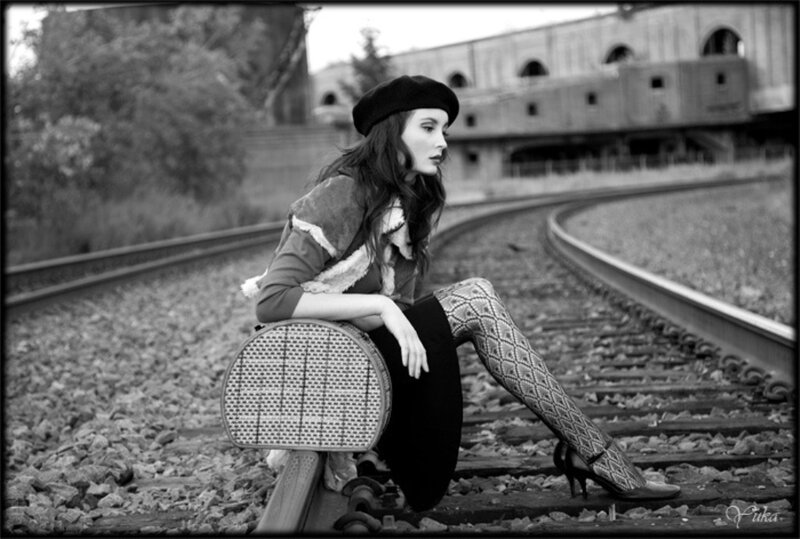 Woman Sitting on Train Tracks — Black, Dramatic