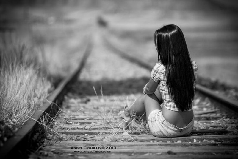 Woman Sitting on Train Tracks — Black, Melancholic, Photograph